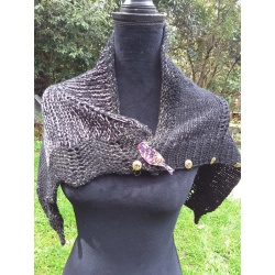 Handknitted small black shawl with pink and gold glittery highlights